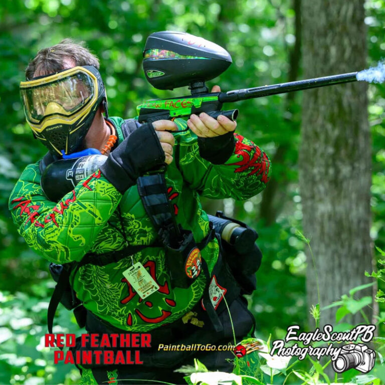 Red Feather paintball Player is in action wearing a green paintball jersey from custompaintball.co